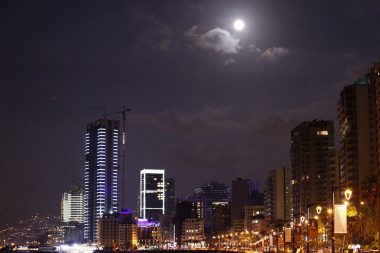 Light of full moon mixing with the city lights of Beirut